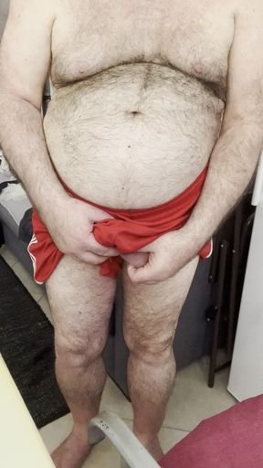 Coach Karl's Balls Accidentally Slip Out of His Gym Shorts, While Stroking His Cock.