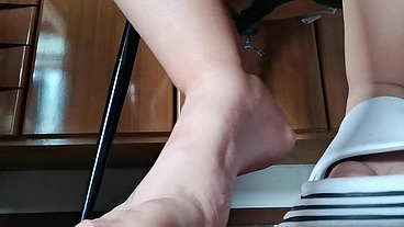 Feet under the table in huge slippers - Extreme close up natural dirty feet