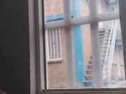 masturbating in the window facing the street