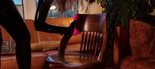 Katya Kova rides her dildo in a latex catsuit, corset, and gloves