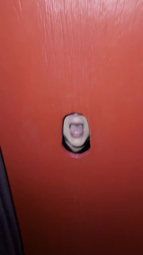 Swinging couple enjoys a glory hole blowjob