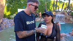 Inked bombshell shows off big boobs at pool party game show