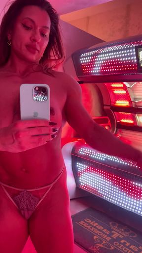 Woman in bikini at tanning booth