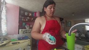 Wearing an apron and washing dishes