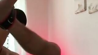 Lover stuffing subs butt with big sex toy while inside chastity cage