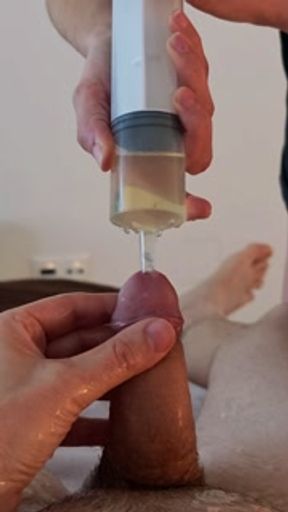 Piss injection. She injects her piss into his urethra.