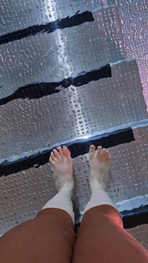 Goddess dips perfect little toes in cold water pool