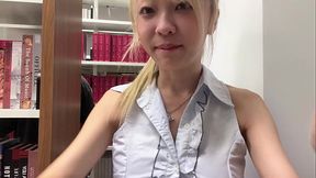 Asian girl masturbates in library while someone reads right next to her
