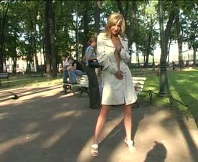 Blonde adorable Russian girl in white raincoat shows off her pussy