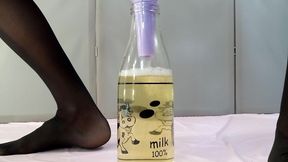 adult with big tits pisses in a bottle through a funnel