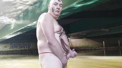 Fat pig Pascal masturbates in the humidity and mud under a bridge