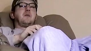 Cute amateur Jack with glasses masturbates on a leather sofa