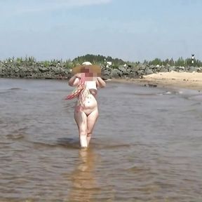 Naked hot MILF on a nude beach.