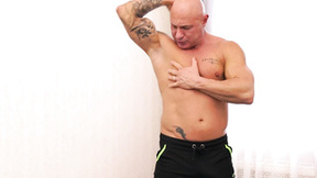 ”Muscular tatted hunk Den Fitness strokes his hard shaft solo”