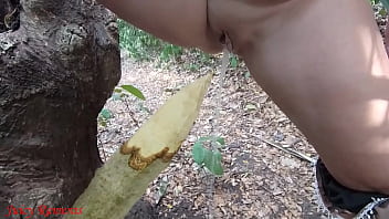 Perverted mature slut squirts piss on wooden stake in forest