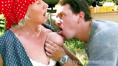 German granny in red headscarf enjoys outdoor titjob and spooning with younger man