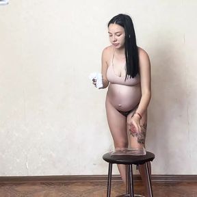 Pregnant Girl Trying On White and Tan Pantyhose