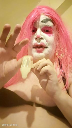 TV clown slut sucking out the contents of a condom