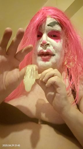 TV clown slut sucking out the contents of a condom