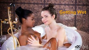 Tiny black girl eats white girl's twat in the bathtub