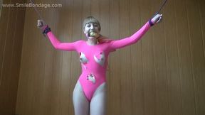 Gagged with knotted cleave gag barefoot Amanda in torn pink leotard, tied standing with her hands wide-spread, is getting tickled by the man (HD WMV)