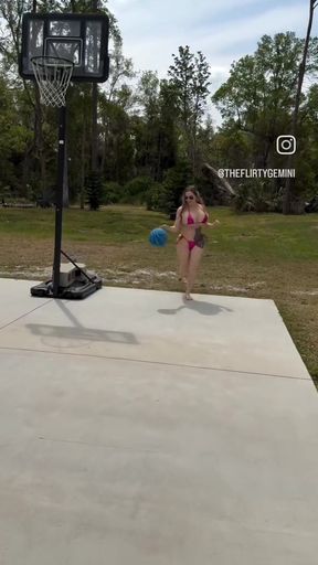 American blonde babe shows off big tits in micro bikini