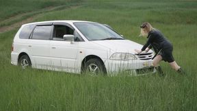 Russian long-legged beauty stuck on the car - pedal pumping