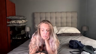 Tattooed blonde taking off her clothes smokes her vape naked