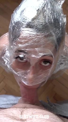 Plastic-wrapped mummy Candie Cross on her knees, eyes begging through the wrap while I fuck her throat raw