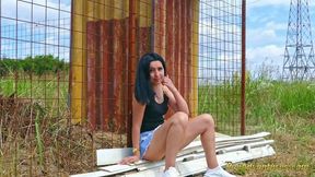 Sexy brunette quick pee next to a house in construction