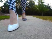 Crossdresser in short dress and heels walking around a park