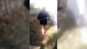 Mature grandmother walking naked outdoors