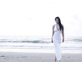 Spice Mu is playing on the beach in a hawt white constricted-fitting outfit.