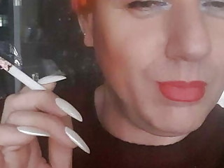 transvestite Sonyastar smokes, long nails, red hair