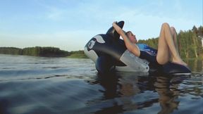 Alla has fun riding a black inflatable whale on the lake !!!