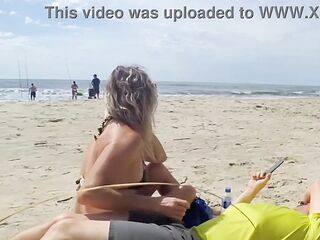 Milf makes stranger ejaculate with skillful handjob right on the beach