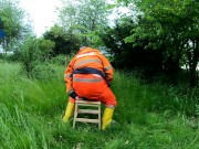 Riding dino toy in garden wearing hivis and rubber boots