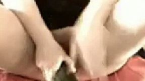 A long and big cucumber is used as a dildo by webcam chick