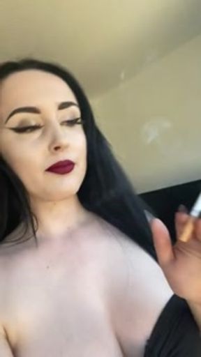 Casually smoking a cork cigarette with dark lipstick on