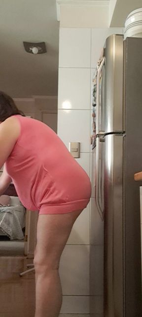 in the kitchen half-dressed