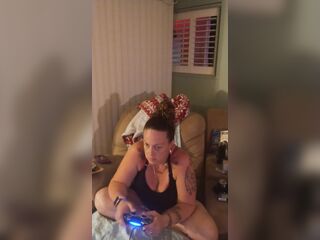 Nice-looking cutie in ebony mini suit lifts up her costume and play fortnite during the time that smokin' cigarettes
