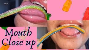 close-up of mouth and tongue while eating candies