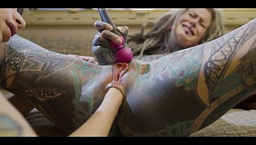 Petite tattooed blonde plays with big dildos in girl-on-girl action