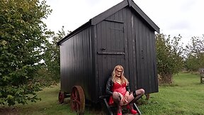 Pvc-clad trans person cumming outdoors in the rain