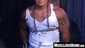 MuscleJockBound.com - Bound by chains, tattooed man in uniform endures rough and erot