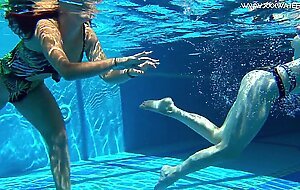 Sexy babes with big tits swim underwater in the pool
