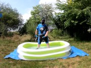 Cyclist pup in pool - cooling down and pawing off