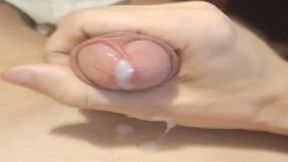 A guy in green swimming trunks jerks off his dick, gets pleasure and ends up with cum and moans
