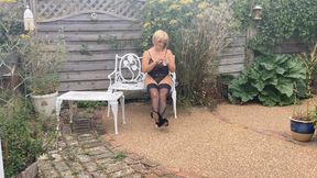 In a country garden on white bench, smoking