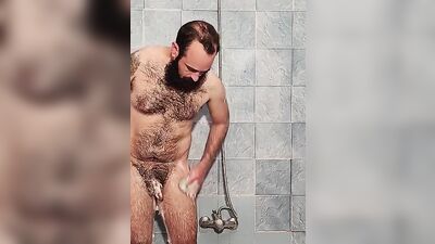 Amateur bear is playing with his dildo under the shower